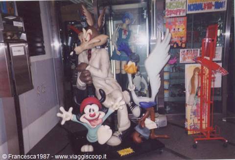 Looney Tunes character statues displayed in a shop window