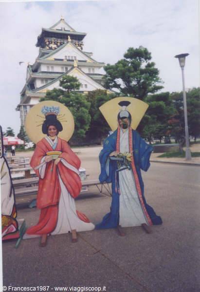 Cardboard cutouts in kimonos in front of Osaka Castle