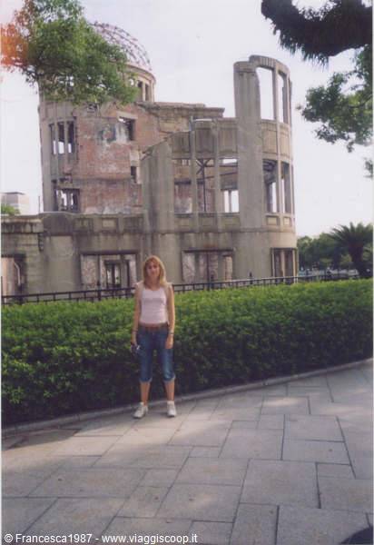Blonde woman in jeans beside the Hiroshima atomic bomb dome