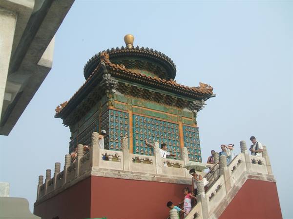 Tourists on stairs of tile-decorated pavilion at the Summer Palace