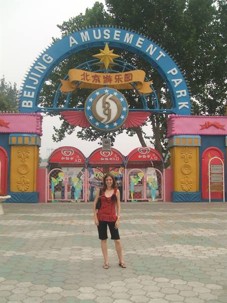 Woman in red and black posing at the Beijing Amusement Park entrance