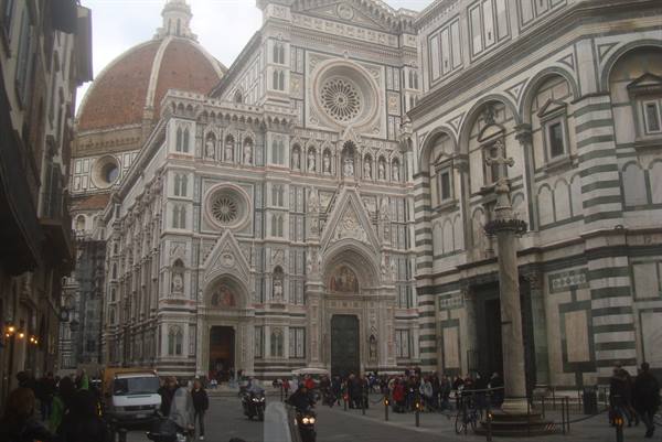 White and green marble facade of Florence Cathedral with Brunelleschi's dome
