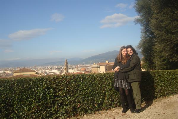 Couple embracing by a hedge, Florence with its bell tower in the background