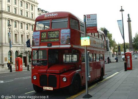 Red double-decker bus route 22 at stop, London phone booths