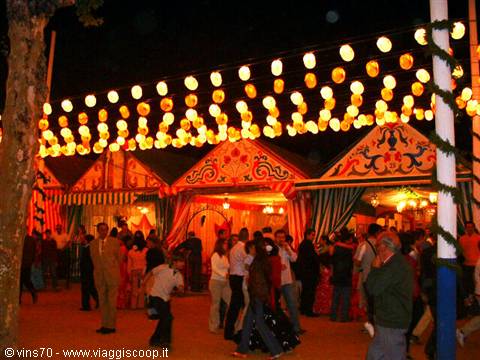 Seville's Feria de Abril: paper lanterns glowing over decorated casetas and dancing crowds