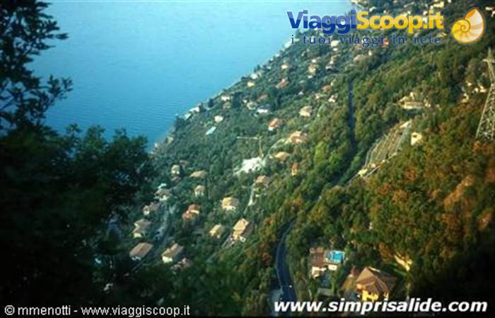 Houses among green woods above the shores of Lake Garda