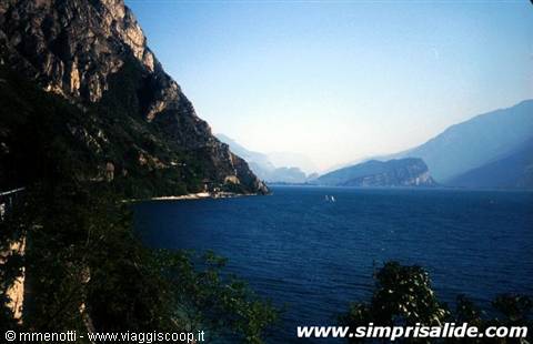 Lake Garda, rocky mountains plunging into blue water with sailboats