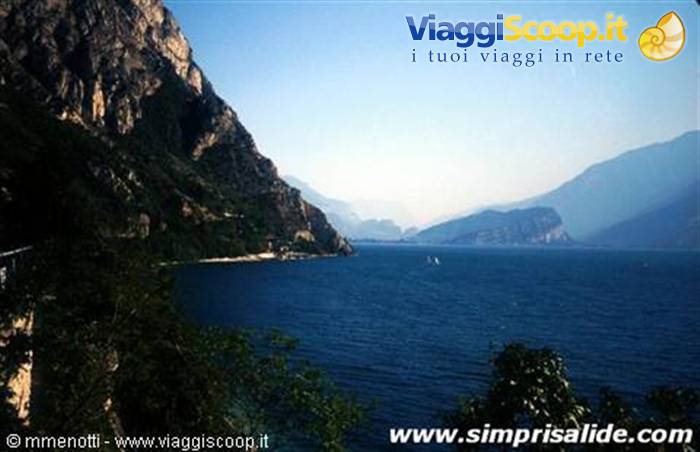 Lake Garda, rocky mountains plunging into blue water with sailboats