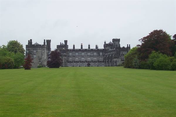 Kilkenny Castle gray stone facade behind a wide green lawn