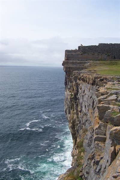 Dry-stone fort perched on limestone cliff edge at Dun Aonghasa, Inis Mór