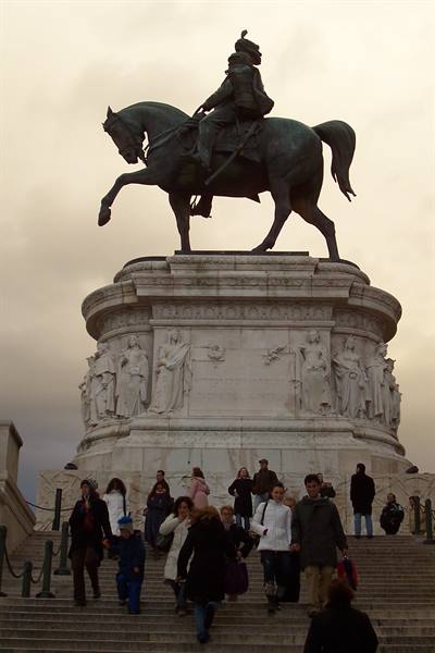 Tourists descend the steps of the bronze equestrian monument on marble base at Gianicolo