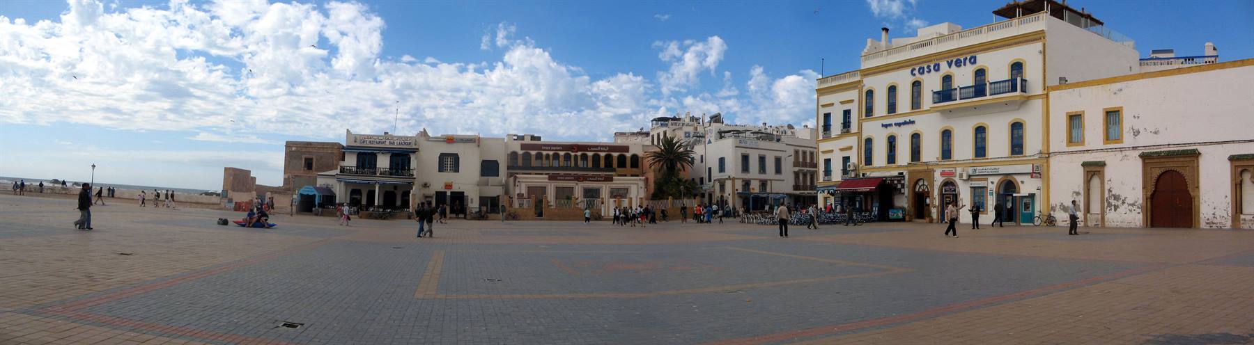 Moulay el Hassan square in Essaouira, white and ochre buildings under scattered clouds