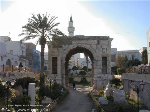 Marcus Aurelius Arch in Tripoli, ancient stone among palms and minaret