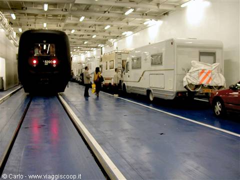 Motorhomes and cars parked inside the Shuttle train wagon deck