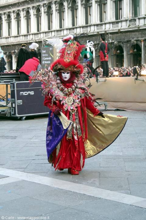 Red and gold costume with white face at Venice Carnival, St Mark's Square