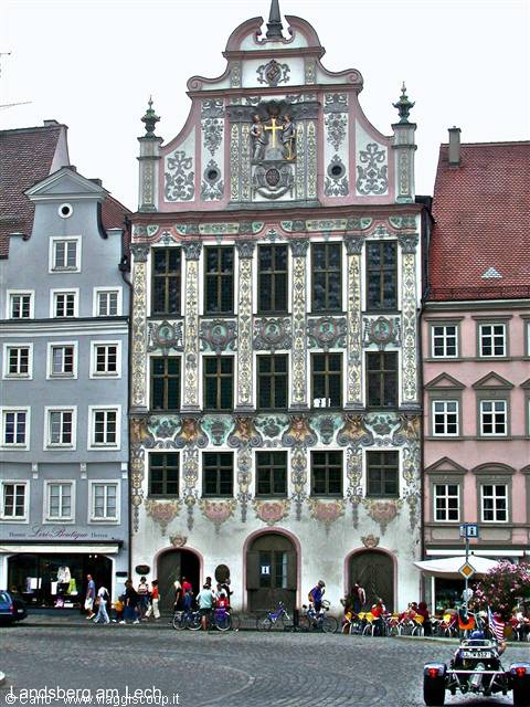 Frescoed facade in Landsberg am Lech, people and bicycles on the square