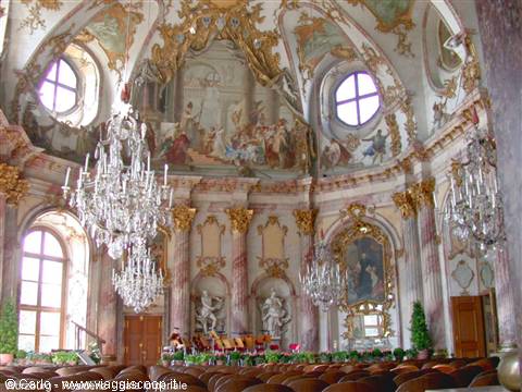Baroque hall with crystal chandeliers, frescoed ceiling and white statues