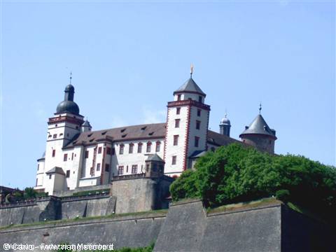 Marienberg Fortress in Würzburg, white towers and stone bastions under blue sky