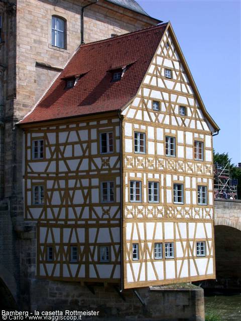 Half-timbered house in Bamberg, brown beams and red roof above the river
