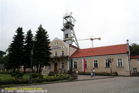 Wieliczka salt mine building with extraction tower, tourists walking by