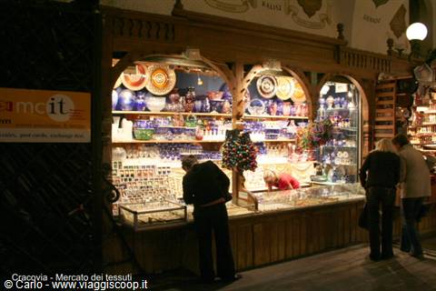 Ceramic and glass stalls lit up in Kraków's Cloth Hall market