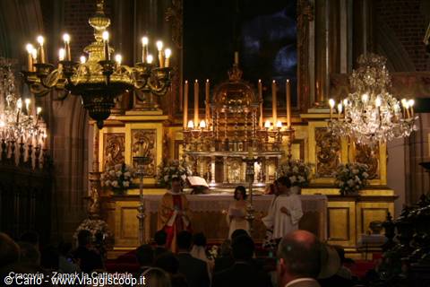 Bride and priest at the gilded altar of Cremona Cathedral