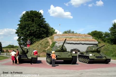 Tourists beside T-34 tanks displayed at Brest Fortress