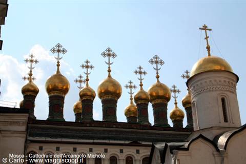 Golden domes of the Archangel Michael Cathedral shine under Moscow sky