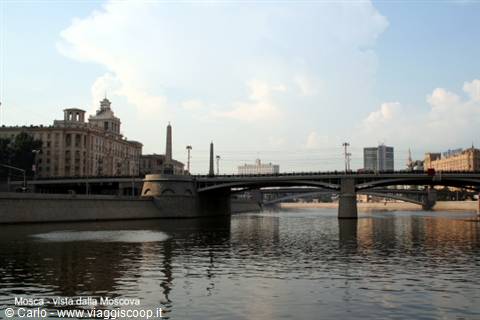 Bridge over the Moskva River among historic buildings and skyscrapers, morning light