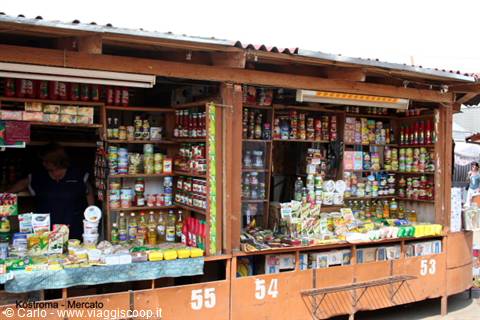Wooden market stalls in Kostroma, vendor among jars and bottles