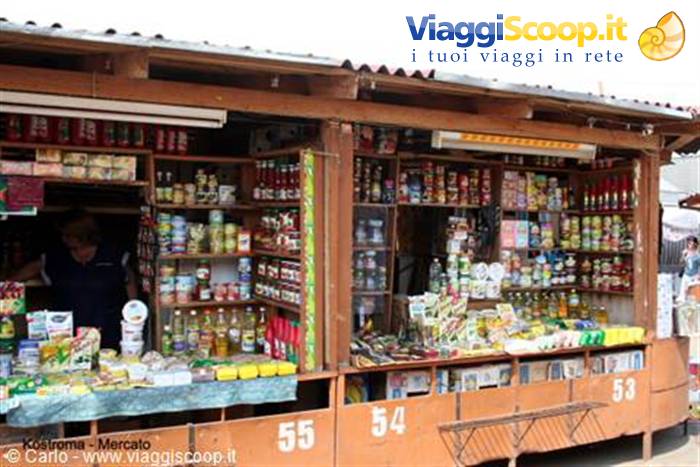 Wooden market stalls in Kostroma, vendor among jars and bottles