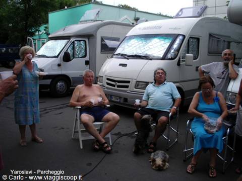Motorhome travelers parked in Yaroslavl, drinking tea beside their campervans