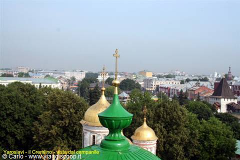Gilded and green enamel domes of Yaroslavl Kremlin rising above the trees