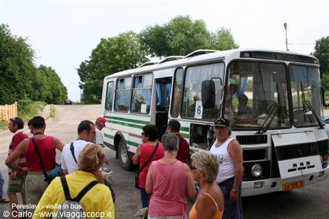Tourists boarding a white and green bus in Pereslavl
