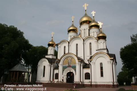 Nikolsky Monastery in Pereslavl, white church with golden domes under grey sky