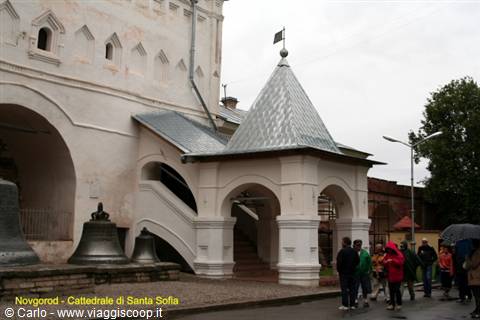 Novgorod: old bells at Saint Sophia Cathedral, visitors under the rain