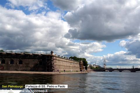 Granite walls of the Peter and Paul Fortress on the Neva under heavy clouds