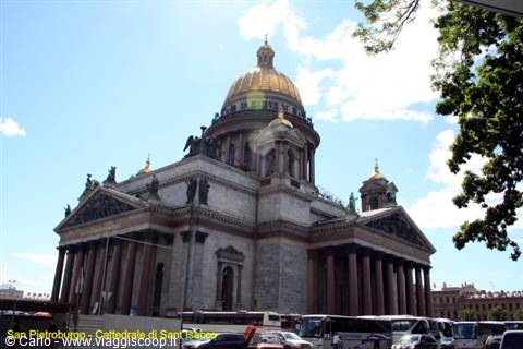 Saint Isaac's Cathedral in Saint Petersburg, golden dome among buses and green branches