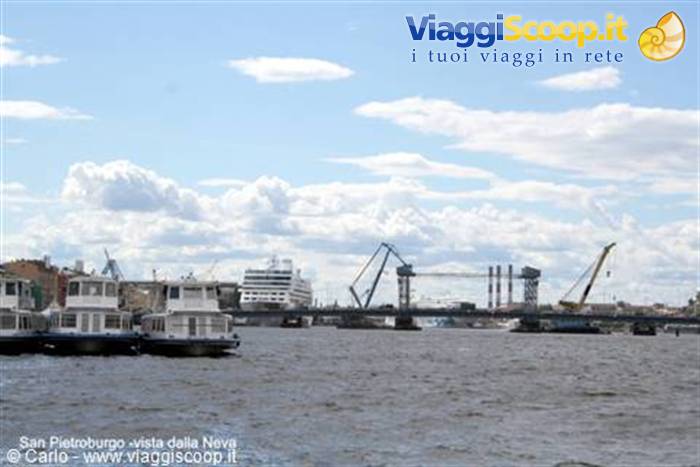 Boats on the Neva river in Saint Petersburg, cranes and cruise ship under clouds