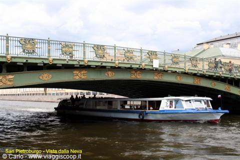 Boat passing under the green ornate bridge over the Neva, Saint Petersburg