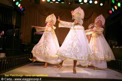 Dancers in white Russian costumes with kokoshniks perform on stage in Saint Petersburg