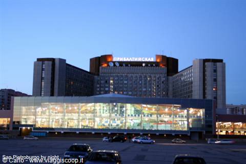 Primorskaya station lit up at night in Saint Petersburg, glowing glass facade