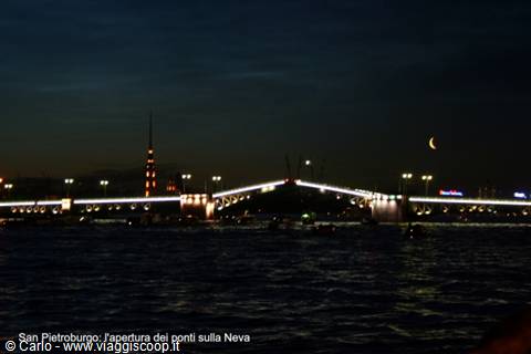 Saint Petersburg: lit drawbridge opened over the Neva, crescent moon in night sky