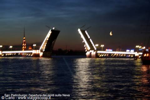 Illuminated drawbridge opening over the Neva in Saint Petersburg, crescent moon