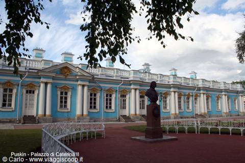 Bust on pedestal in front of the pale blue Catherine Palace facade, Pushkin