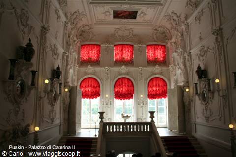 Baroque staircase of Catherine Palace in Tsarskoye Selo, red curtains and white stucco