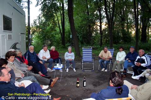 Group of campers sitting in a circle beside their motorhome, Saint Petersburg