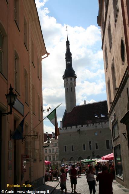Tallinn's Gothic town hall with its spire rises above the colorful square