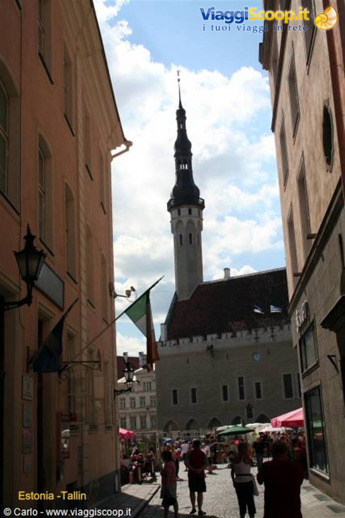Tallinn's Gothic town hall with its spire rises above the colorful square