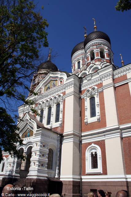 Alexander Nevsky Orthodox Cathedral in Tallinn, black domes and red bricks under blue sky